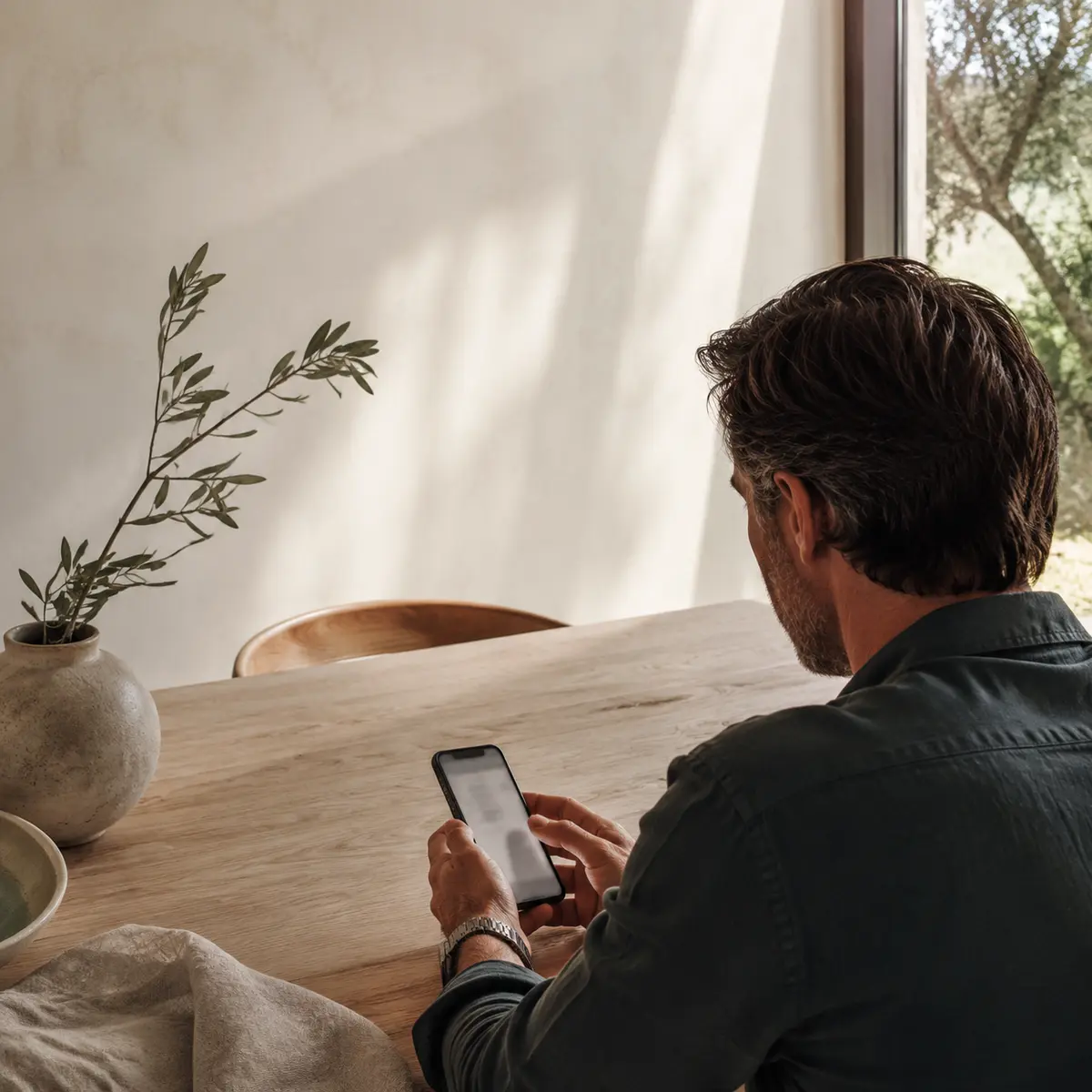 A person completing a profile on a phone in a quiet home